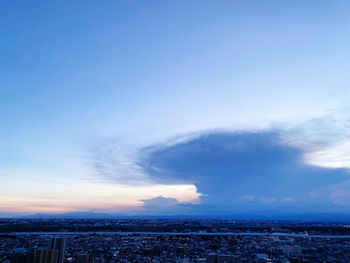 Aerial view of city against sky during sunset