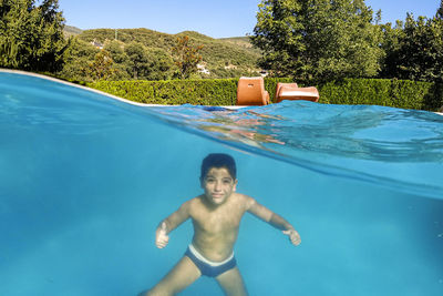 Portrait of shirtless boy in swimming pool