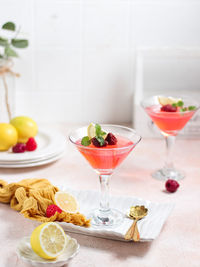 Sweet berry jelly in glass with lemon slice and berry and mint leaves. brightmood food photography