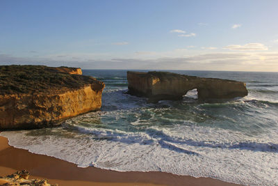 Scenic view of rock formations in ocean against sky