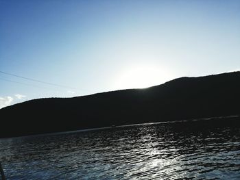 Scenic view of silhouette mountains against clear sky