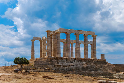 Old ruins of temple against cloudy sky