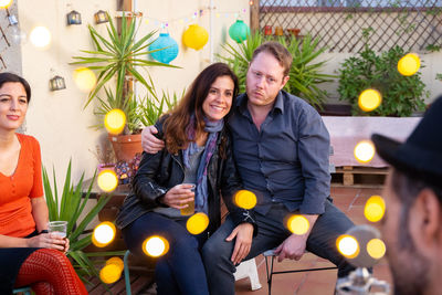 Young couple sitting outdoors