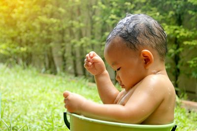 Boy sitting on field