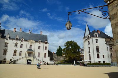 Low angle view of buildings in town against sky