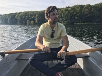 Man sitting in boat on lake