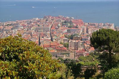 High angle view of townscape by sea