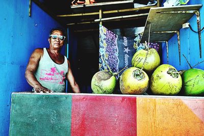 Portrait of man with fruits in market