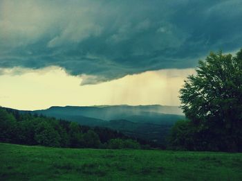 Scenic view of landscape against cloudy sky