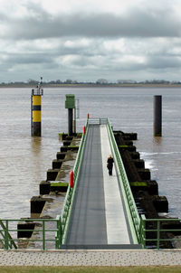 Pier over river against sky