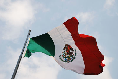Low angle view of mexican flag against clear blue sky