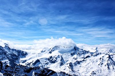 Scenic view of snowcapped mountains against sky