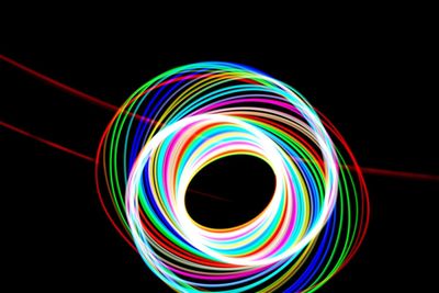 Close-up of colorful light over black background