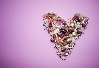 Close-up of heart shape against pink background