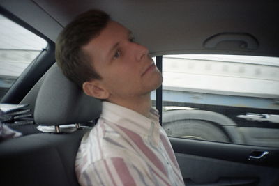 Portrait of man sitting in car