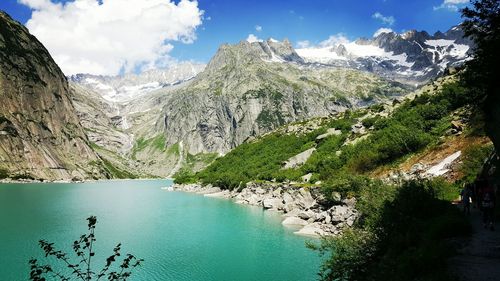 Scenic view of lake against cloudy sky