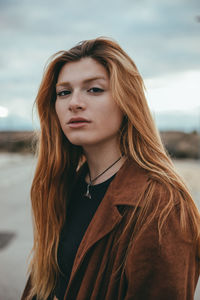 Portrait of beautiful young woman standing outdoors