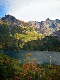 Scenic view of lake and mountains against sky