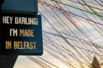 Low angle view of road sign against building in city