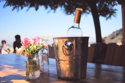 Beer bottle in ice bucket on table