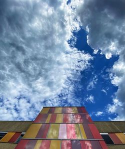 Low angle view of building against cloudy sky