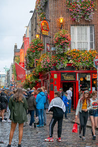 Rear view of people walking on street