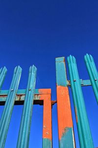 Low angle view of metallic structure against blue sky