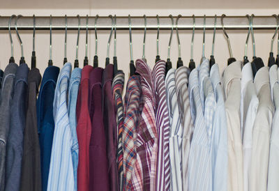 Close-up of clothes hanging on rack at home