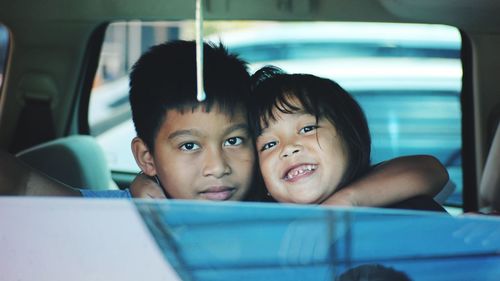 Portrait of siblings in car