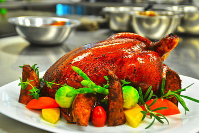 Close-up of roast chicken in plate on table
