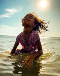 Girl swimming in sea during summer