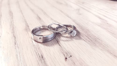 Close-up of wedding rings on table