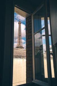 Low angle view of eiffel tower seen through window