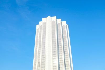 Low angle view of skyscraper against clear blue sky