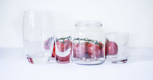 Close-up of drink in glass on table against white background