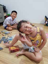 Portrait of happy friends sitting on table