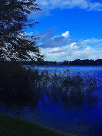 Scenic view of lake against cloudy sky