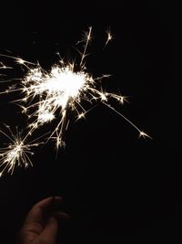 Low angle view of firework display at night