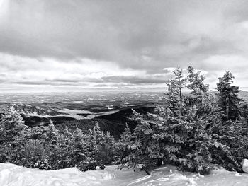 Scenic view of snow covered land against sky