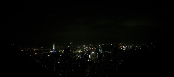 Illuminated cityscape against sky at night