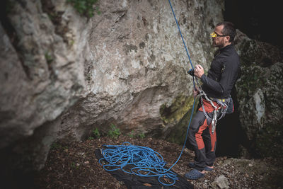 Full length of man rock climbing