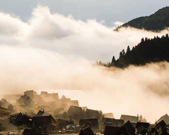 Panoramic view of buildings in mountains against sky