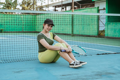 Side view of young woman exercising in gym