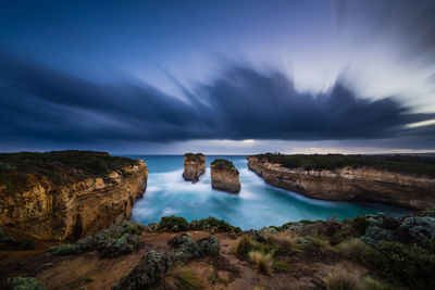 Panoramic view of sea and rocks against sky