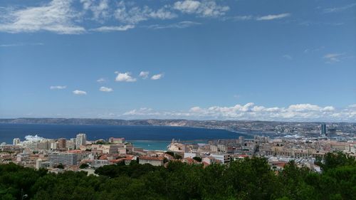 View of town by sea against sky
