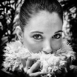 Portrait of woman holding feather shawl