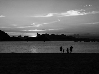 Family contemplating the sunset 