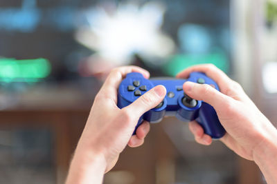 Close-up of hands holding video game remote control