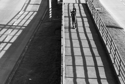 High angle view of woman walking on footpath