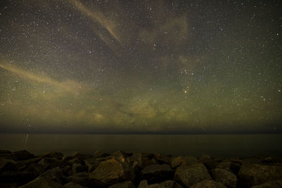 Scenic view of sea against sky at night